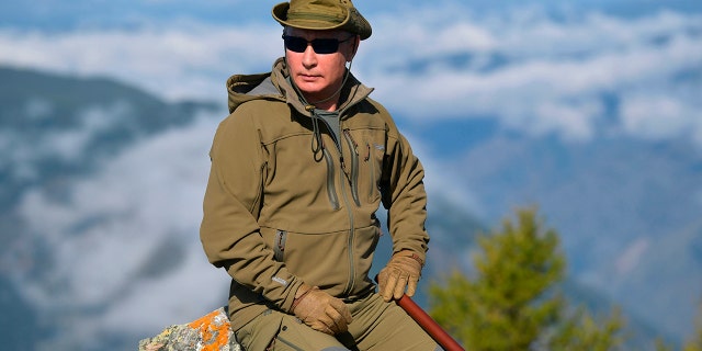 Putin rests on a hill in Siberia during a break from state affairs ahead of his birthday. (Alexei Druzhinin, Sputnik, Kremlin Pool Photo via AP)