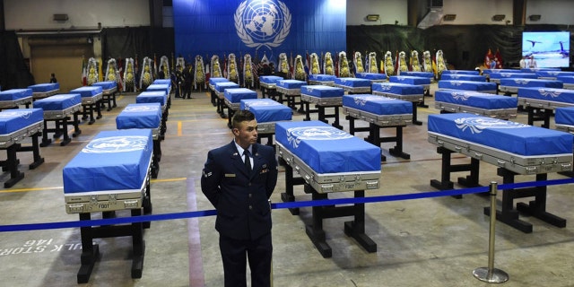 A U.S. airman stands guard next to caskets containing remains of U.S. soldiers killed in the Korean War and collected in North Korea before a repatriation ceremony at Osan Air Base in Pyeongtaek, South Korea, in August 2018.