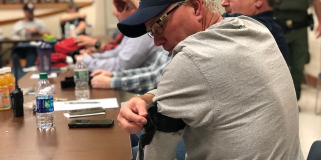 Washington County Community College master carpenter John Charters practices applying a tourniquet at the training.