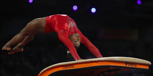 Gold medalist Simone Biles of the United States performs on the vault in the women's apparatus finals at the Gymnastics World Championships in Stuttgart, Germany, Saturday, Oct. 12, 2019. (AP Photo/Matthias Schrader)