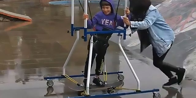 His mom helped push him around the park and up and down the ramps.