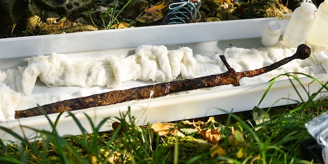 The sword after being pulled out of the river. (Credit: Central European News)