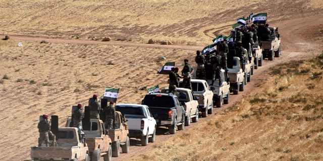 Turkey-backed Free Syrian Army fighters heading toward the Syrian town of Tal Abyad from the Turkish border town of Akcakale, Turkey, on Thursday.