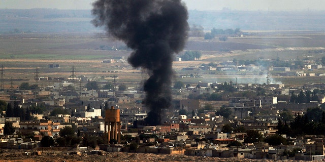 In this photo taken from the Turkish side of the border between Turkey and Syria, in Ceylanpinar, Sanliurfa province, southeastern Turkey, smoke billows from a fire on a target in Ras al-Ayn, Syria, caused by shelling by Turkish forces, on Thursday last week. (AP)