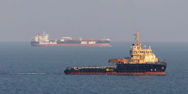 This image taken from aboard a Royal Navy Wildcat helicopter patrolling the Gulf as part of the International Maritime Security Construct shows the MV Stena Impero, background, as it sails from the port at Bandar Abbas, Iran, after being released by Iranian officials Friday, Sept. 27, 2019. Iran on Friday released the British-flagged oil tanker it had seized in July 2019, while the country’s president, returning from an annual United Nations meeting, said he had been told the United States had offered to lift sanctions if Tehran returned to the negotiating table over its nuclear program. (Dan Rosenbaum/British Royal Navy via AP)