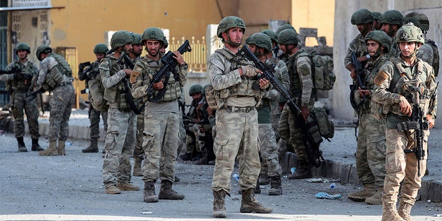 Turkish soldiers secure the Syrian town of Ras al Ayn, in northeastern Syria on Wednesday. (AP/DHA)