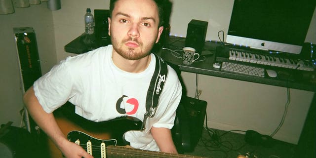 Harry Mockett playing the guitar before he was diagnosed with a brain tumor.