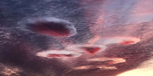 Incredible 'UFO-like' clouds over Gloucestershire as the sunrises over the West Country. October 28, 2019. (Credit: SWNS)