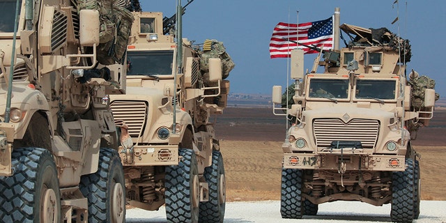 An American military convoy stops near the town of Tel Tamr, north Syria, on Sunday.