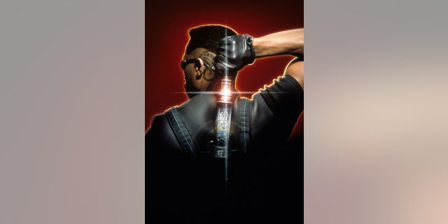 Wesley Snipes holds a katana behind his back in a scene from the film "Blade" in 1999.