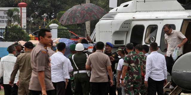 Soldiers carry Wiranto on a stretcher to a helicopter. He appeared to have the left side of his abdomen covered with bandages and an oxygen mask strapped to his face. (AP Photo/Rafsanjani)