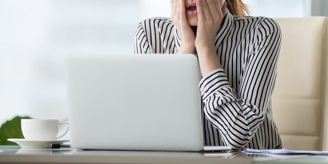 A woman in front of a computer. 