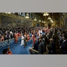 Britain's Queen Elizabeth II, accompanied by Prince Charles, proceed through the Royal Gallery before delivering the Queen's Speech during the State Opening of Parliament in London, Oct. 14, 2019. 