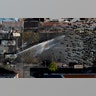 A police water cannon sprays anti-government demonstrators in Valparaiso, Chile, Oct. 26, 2019. 