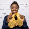 Simone Biles of the United States shows off her five gold medals at the Gymnastics World Championships in Stuttgart, Germany, Oct. 13, 2019.