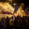 Pro-independence demonstrators, some of them holding flares, march as they take part in a demonstration in Girona, Spain, Oct. 1, 2019. 