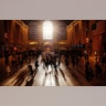 Commuters walk through Grand Central Terminal as the sun rises through the east facade in New York City, Oct. 28.