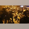 A journalist falls to the ground during clashes between protestors and police in Barcelona, Spain, Oct. 15, 2019. 