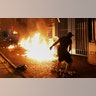 Protesters throw petrol bombs outside the Tsuen Wan police station in Hong Kong, Oct. 2, 2019. 