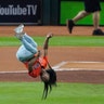 Gymnast Simone Biles does a flip before throwing the ceremonial first pitch before Game 2 of the World Series between the Houston Astros and the Washington Nationals in Houston, Oct. 23, 2019. (AP Photo/Eric Gay)