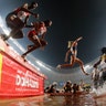 Competitors in the women's 3000-meter steeplechase final run through a water jump at the World Athletics Championships in Doha, Qatar, Sept. 30, 2019. 