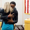 Botham Jean's younger brother, Brandt Jean, hugs convicted murderer and former Dallas Police Officer Amber Guyger after delivering a statement to her after she was sentenced to 10 years in jail in Dallas, Oct. 2, 2019. 
