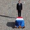 French President Emmanuel Macron pays his respect to former French President Jacques Chirac at Invalides monument in Paris, Sept. 30, 2019.