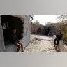 Kids sit by their damaged home in the village of Barisha.? (AP Photo/ Ghaith Alsayed)