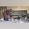 A woman checks damage to her home in the village of Barisha, in Idlib province, Syria, Sunday, Oct. 27, 2019, after an operation by the U.S. military which targeted Abu Bakr al-Baghdadi, the shadowy leader of the Islamic State group. President Donald Trump said Abu Bakr al-Baghdadi died in a U.S. military operation in Syria which targeted the Islamic State group leader. (AP Photo/ Ghaith Alsayed)