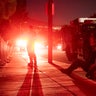 Firefighters from Orange County await further instructions in a blackout during the Tick Fire, Thursday, Oct. 24, 2019, in Santa Clarita, Calif. The dramatic fires and evacuations — near Los Angeles and in the wine country of Northern California — came against a backdrop of power shutoffs that utility companies said were necessary to stop high winds from toppling trees or blowing debris into power lines and starting fires. (AP Photo/ Christian Monterrosa)