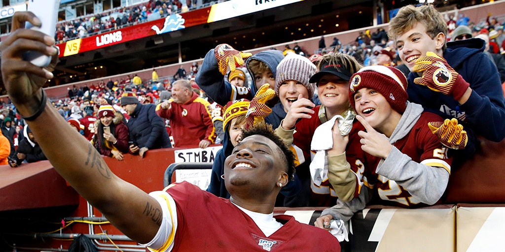 Washington Redskins' fans wearing Superman socks call for