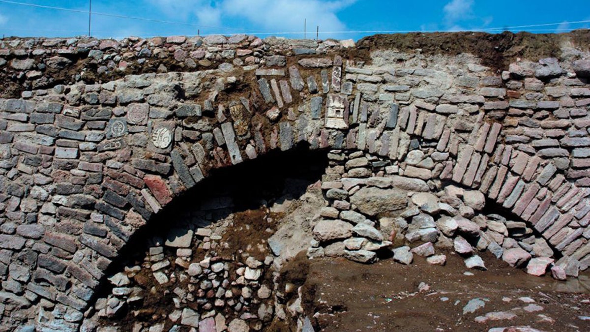 The east end of the tunnel, where the water exited, was decorated in petroglyphs and stucco reliefs. (Image:  Edith Camacho INAH)