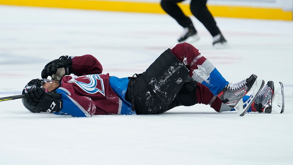 Colorado Avalanche left wing Pierre-Edouard Bellemare lies on the ice after being hit by Columbus Blue Jackets left wing Nick Foligno during the second period of an NHL hockey game, Saturday, Nov. 9, 2019, in Denver. (AP Photo/Jack Dempsey)