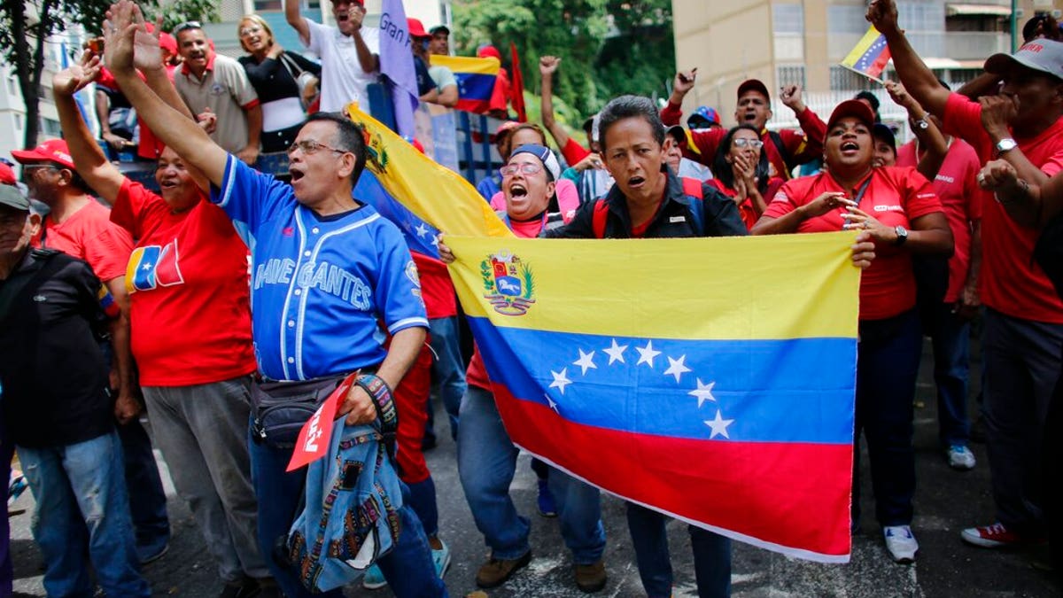 Government supporters chants slogans in favor of President Nicolas Maduro as they march in Caracas, Venezuela last month.
