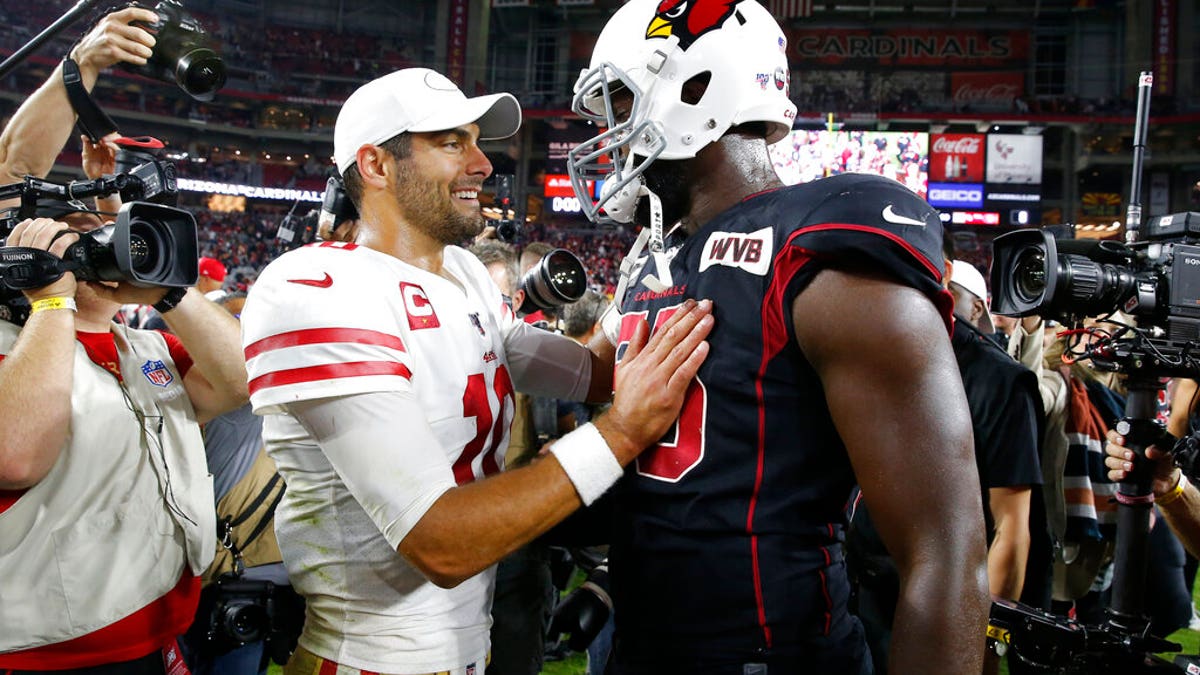 San Francisco 49ers quarterback Jimmy Garoppolo (10) greets Arizona Cardinals linebacker Chandler Jones (55) after an NFL football game, Thursday, Oct. 31, 2019, in Glendale, Ariz. The 49ers won 28-25.