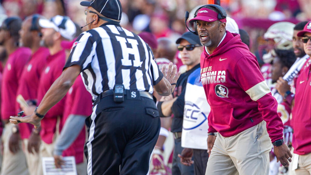 Florida State head coach Willie Taggart, right, disagrees with the referee in the first half of an NCAA college football game against Miami in Tallahassee, Fla.