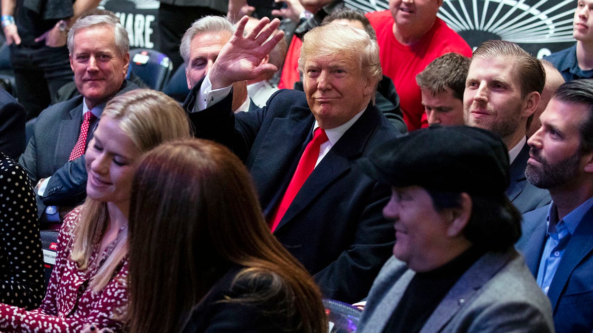 President Trump -- accompanied by (from left) Reps. Mark Meadows and Kevin McCarthy, and sons Eric and Donald Jr. -- waving at Madison Square Garden while attending the UFC 244 fights Saturday in New York City. (AP Photo/ Evan Vucci)