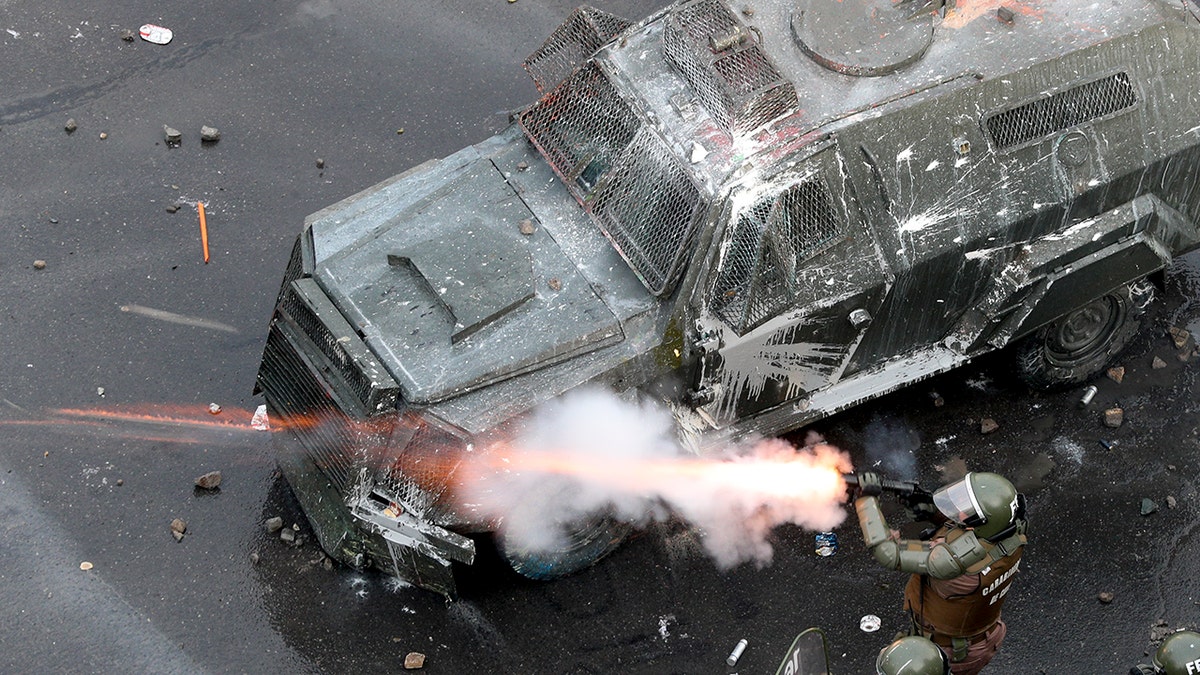Police fire tear gas at protesters during an anti-government protest in Santiago, Chile, Monday, Nov. 4, 2019.