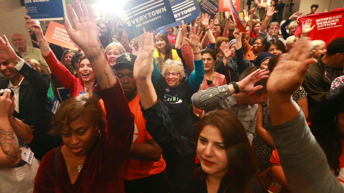 Democratic supporters cheer their candidates at a Democratic Party event in Richmond, Va., Tuesday, Nov. 5, 2019. All seats in the Virginia House of Delegates and state Senate are up for election. (AP Photo/Steve Helber)