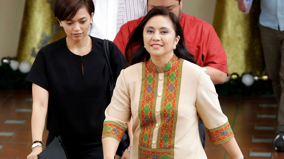 Philippine Vice-president Leonor "Leni" Robredo walks to a conference to deliver her statement Wednesday, Nov. 6, 2019, in suburban Quezon city northeast of Manila, Philippines.