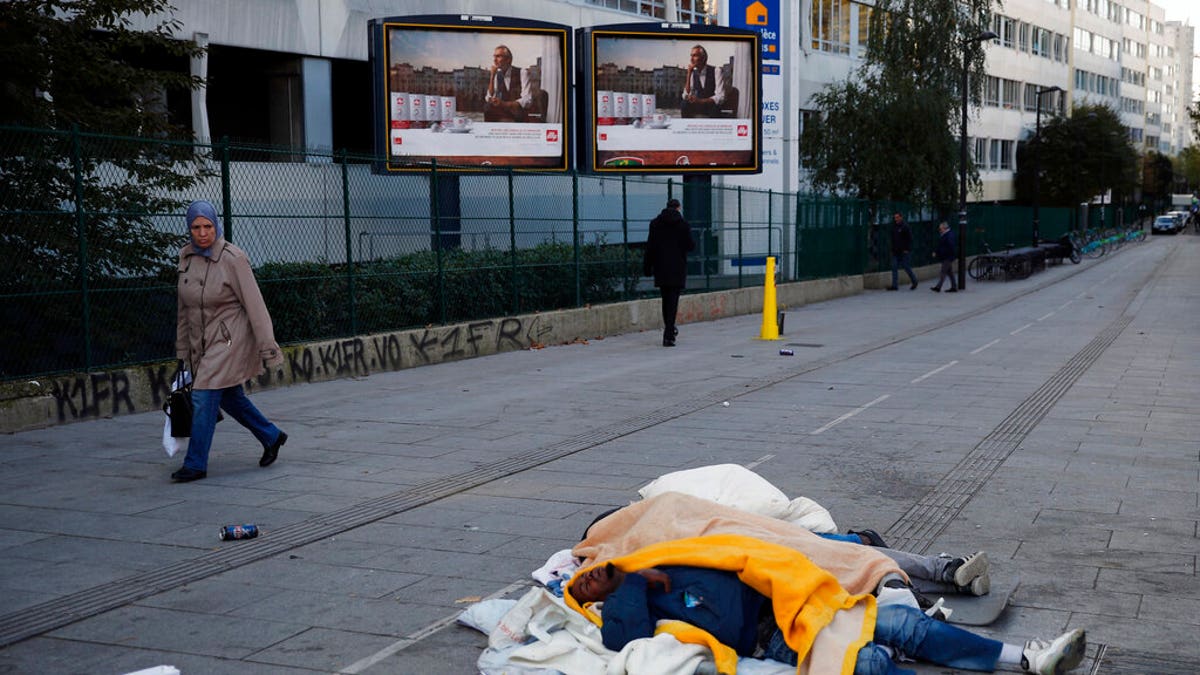 Homeless migrants sleep in the street in Paris, France, Wednesday, Nov. 6.