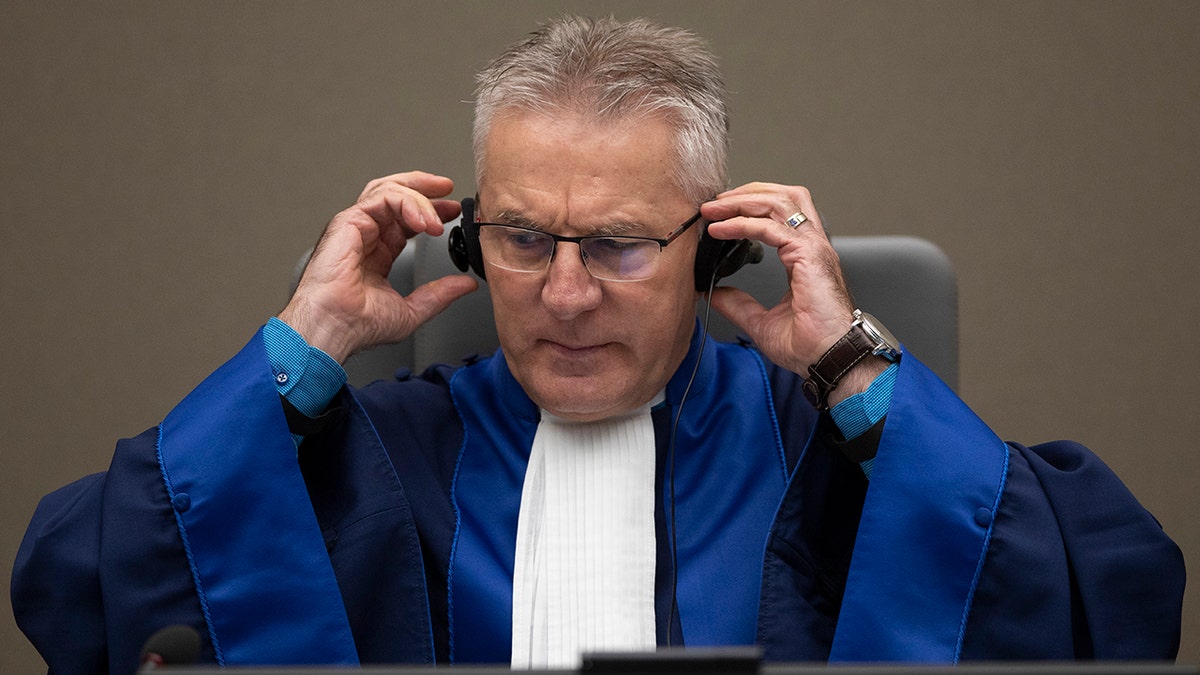 Presiding ICC judge Robert Fremr prepares to read the sentence for Congolese militia commander Bosco Ntaganda in the courtroom of the International Criminal Court in The Hague, Netherlands, Thursday, Nov. 7, 2019. (AP Photo/Peter Dejong, Pool)