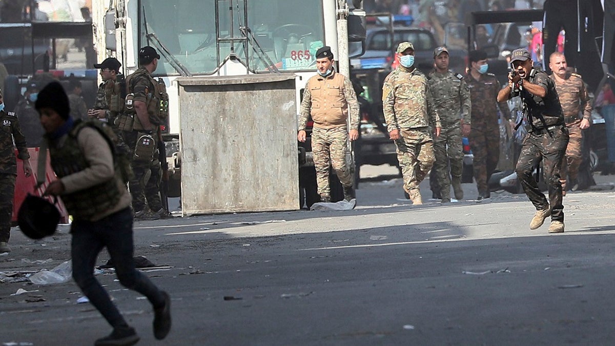 Iraqi security forces try to disperse anti-government protesters during ongoing protests in Baghdad, Iraq this week. (AP Photo/Hadi Mizban)