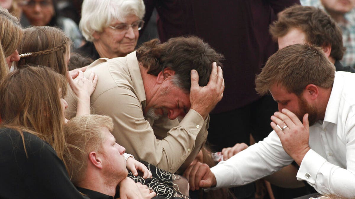 David Langford being consoled during the funeral service for his wife and sons in La Mora, Mexico, on Thursday.