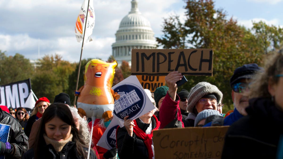 Demonstrators marching on Pennsylvania Avenue protesting against climate policies and President Trump, in Washington last week. (AP Photo/Jose Luis Magana)