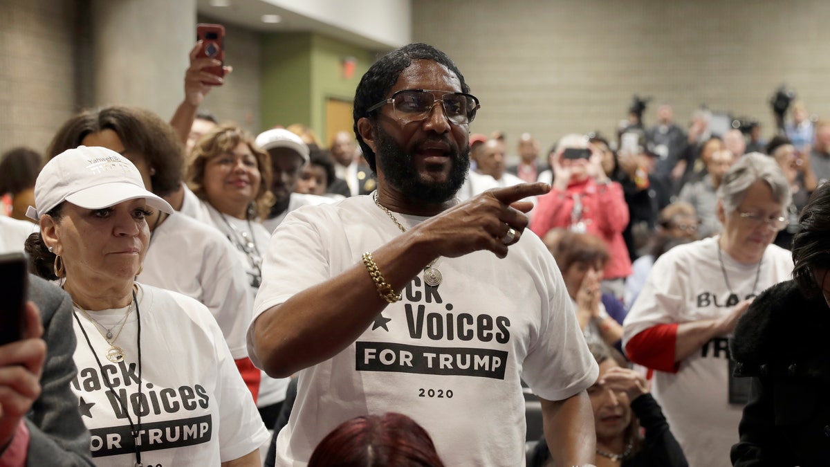 Supporters of President Donald Trump wait to listen to him speak during the launch of "Black Voices for Trump," at the Georgia World Congress Center, Friday, Nov. 8, 2019, in Atlanta. (AP Photo/ Evan Vucci)