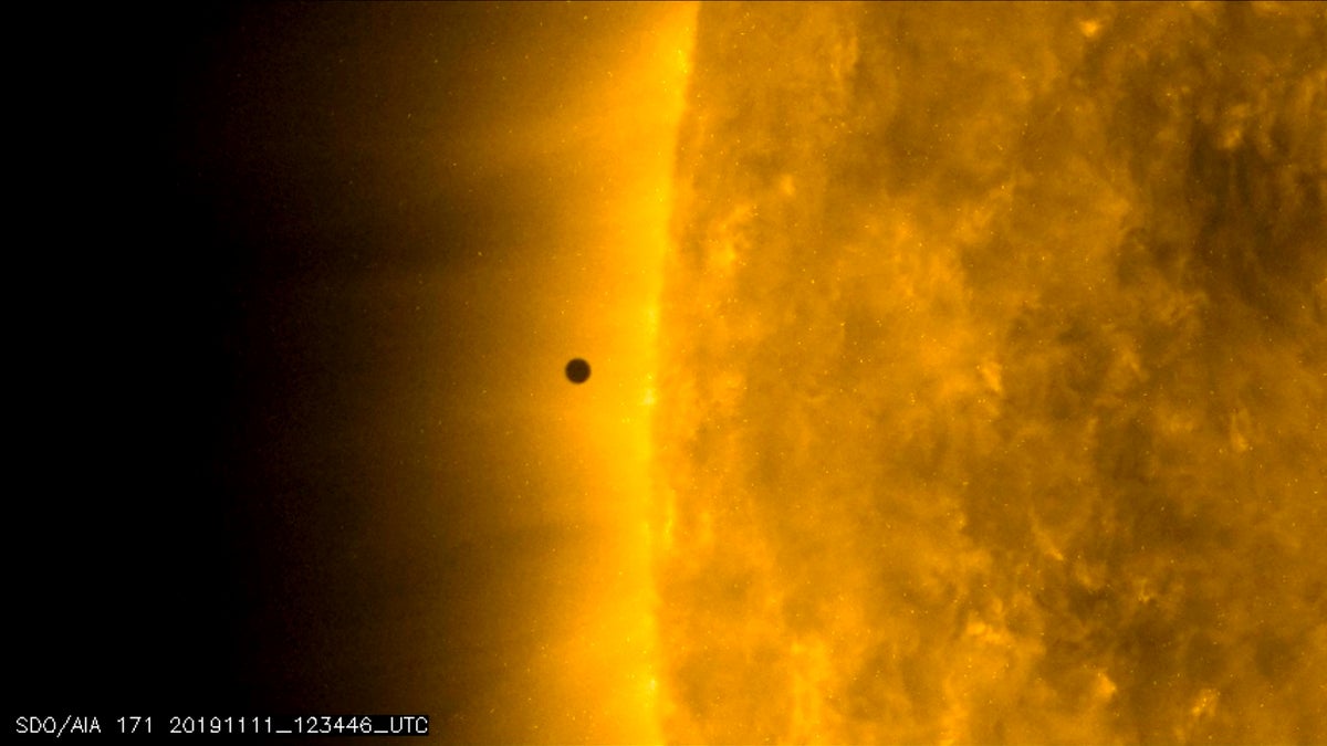 This still image from video issued by NASA's Solar Dynamics Observatory shows Mercury as it passes between Earth and the sun.The solar system's smallest, innermost planet resembles a tiny black dot during the transit. (NASA Solar Dynamics Observatory via AP)