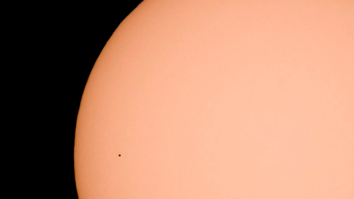The planet Mercury transits across the face of the sun, as seen from Kekesteto, Hungary's highest mountain peak, Monday, Nov. 11, 2019. Stargazers used solar filtered binoculars and telescopes to spot Mercury, the solar system's smallest, innermost planet, as a tiny black dot as it passed between Earth and the sun on Monday. (Peter Komka/MTI via AP)