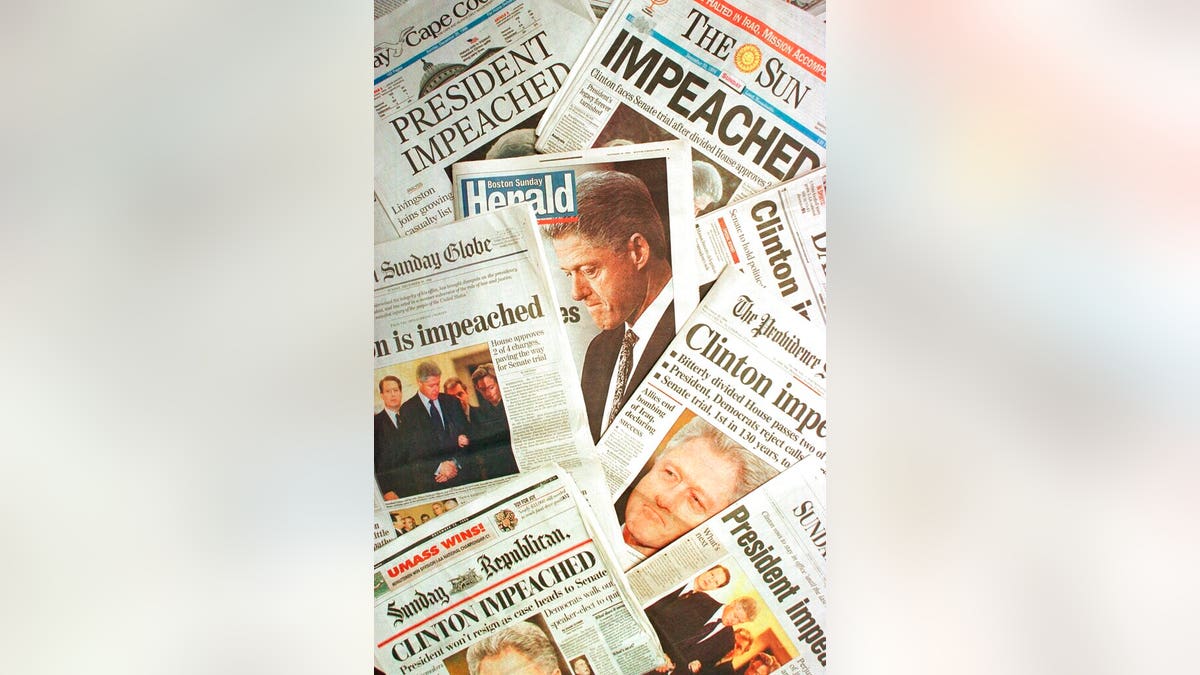 The Dec. 20, 1998 editions of newspapers from Massachusetts and Rhode Island with headlines of President Clinton's impeachment. (AP Photo/Peter Lennihan, File)
