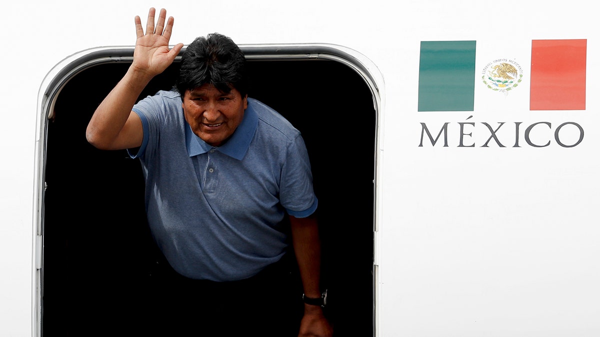 Morales waves upon arrival to Mexico City, Tuesday, Nov. 12, 2019. (AP Photo/Eduardo Verdugo)